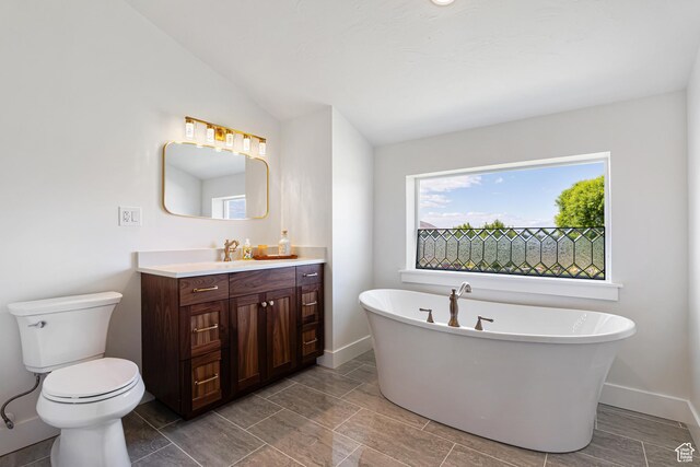 5186 W 9970 S, Payson, UT 84651 - bathroom with toilet, vanity, a freestanding tub, and baseboards