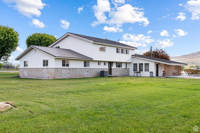 5186 W 9970 S, Payson, UT 84651 - back of property with stucco siding, stone siding, a standing seam roof, and a lawn