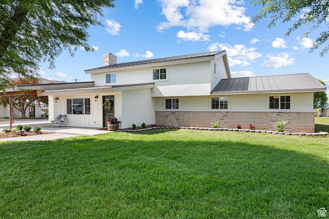 5186 W 9970 S, Payson, UT 84651 - view of front facade with a patio, a chimney, a standing seam roof, a front lawn, and stucco siding