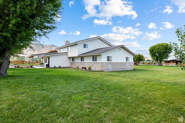 5186 W 9970 S, Payson, UT 84651 - back of property with stucco siding, a chimney, a yard, and a patio area