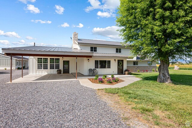 5186 W 9970 S, Payson, UT 84651 - back of house with a chimney, a yard, a standing seam roof, metal roof, and a patio