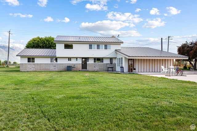 5186 W 9970 S, Payson, UT 84651 - back of house featuring a yard, a patio, central air condition unit, and metal roof