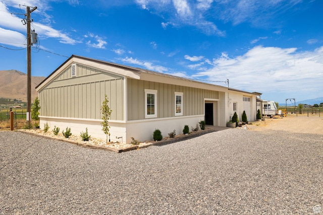 manufactured / mobile home with fence and a mountain view