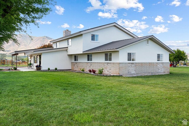 5186 W 9970 S, Payson, UT 84651 - view of side of property featuring stucco siding, a chimney, a patio area, a yard, and stone siding