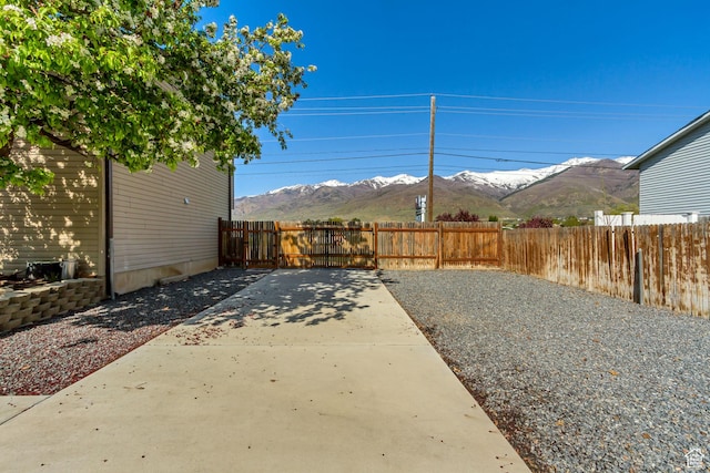 572 S Main St, Kaysville, UT 84037 - view of yard with fence, a mountain view, and a patio