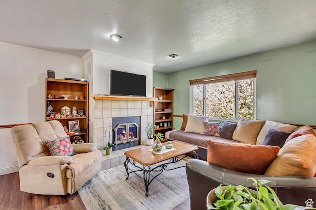 572 S Main St, Kaysville, UT 84037 - living area with baseboards, a tiled fireplace, and wood finished floors