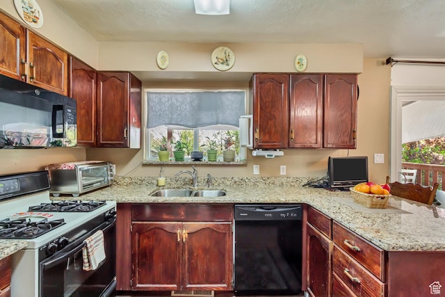 572 S Main St, Kaysville, UT 84037 - kitchen with a toaster, light stone counters, a sink, black appliances, and a peninsula