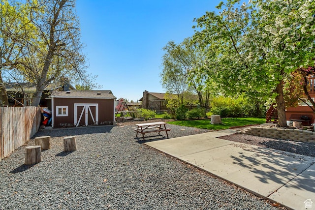 572 S Main St, Kaysville, UT 84037 - view of yard featuring an outdoor structure, fence, and a storage unit