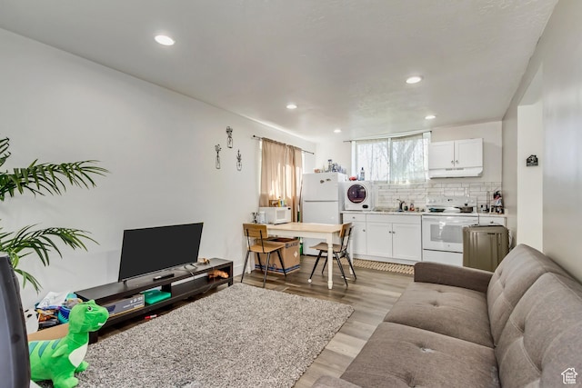 572 S Main St, Kaysville, UT 84037 - living area with stacked washer and dryer, recessed lighting, and light wood-style floors