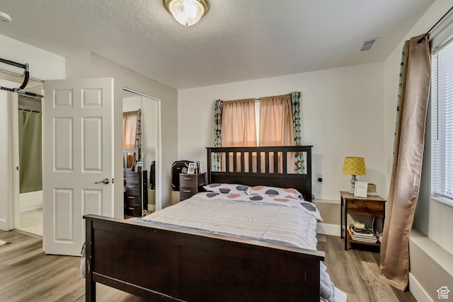 572 S Main St, Kaysville, UT 84037 - bedroom with light wood finished floors, baseboards, visible vents, and a closet