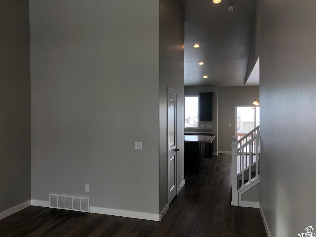 312 W Sapphire Dr, Tooele, UT 84074 - hallway with visible vents, baseboards, and dark wood-style floors