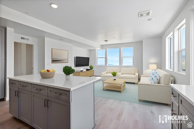 living area with recessed lighting, visible vents, and light wood-type flooring