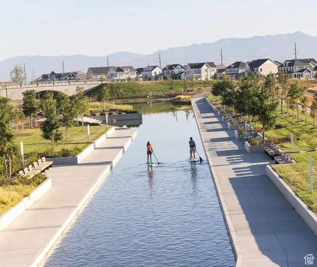 view of property's community featuring a residential view and a water and mountain view