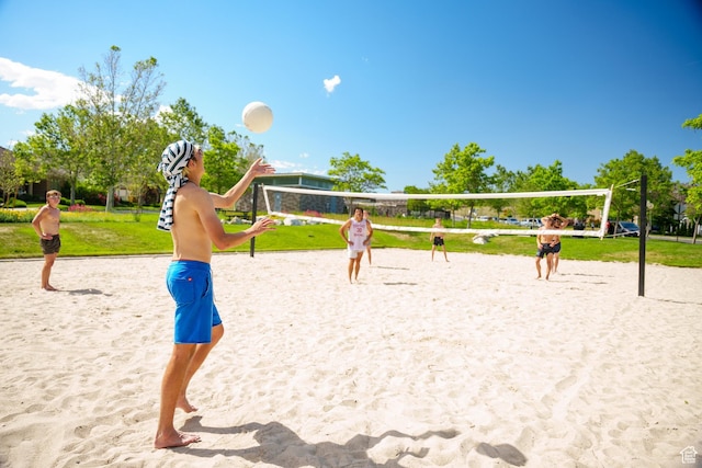 view of home's community featuring a yard and volleyball court