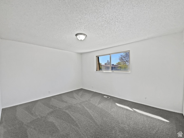 3445 W 3650 S, West Valley City, UT 84119 - spare room with dark carpet, baseboards, and a textured ceiling