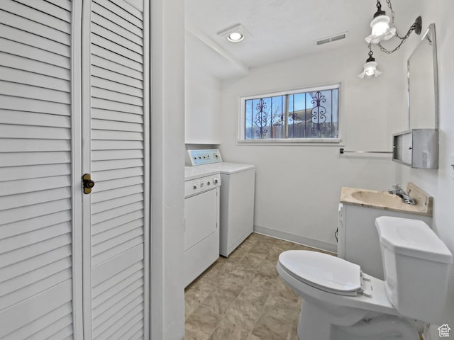 3445 W 3650 S, West Valley City, UT 84119 - bathroom with a sink, toilet, baseboards, visible vents, and washer and dryer