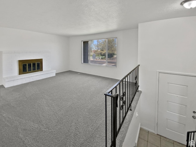 3445 W 3650 S, West Valley City, UT 84119 - staircase with a brick fireplace, carpet, and a textured ceiling