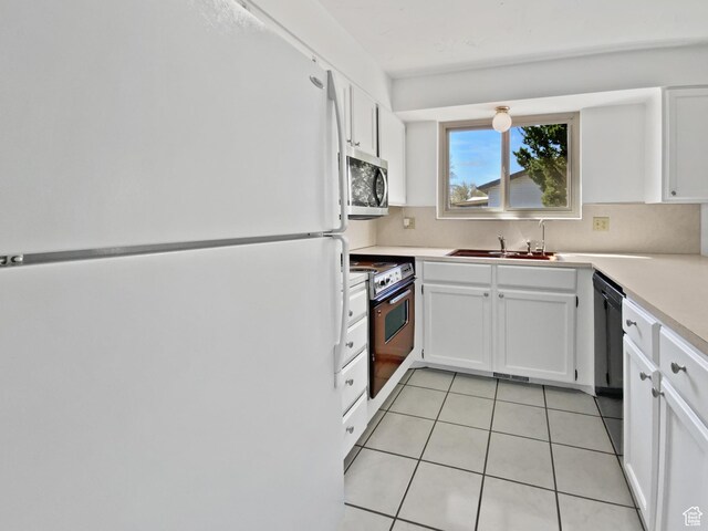 3445 W 3650 S, West Valley City, UT 84119 - kitchen featuring white cabinets, range with electric stovetop, a sink, stainless steel microwave, and freestanding refrigerator