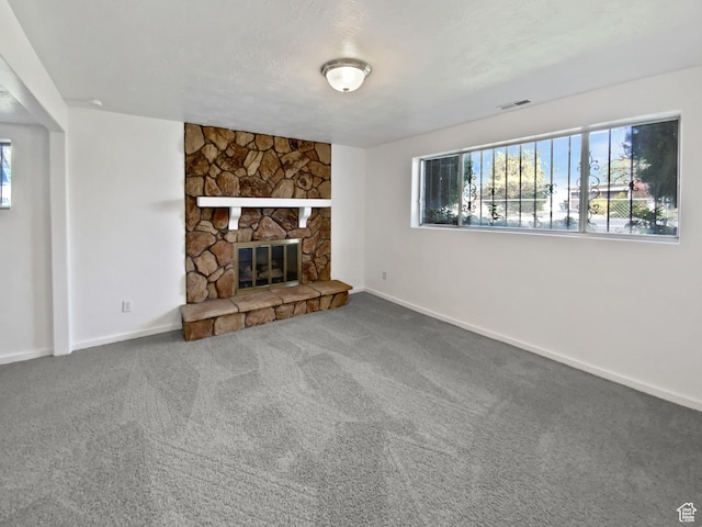 3445 W 3650 S, West Valley City, UT 84119 - unfurnished living room featuring a fireplace, carpet, visible vents, and baseboards