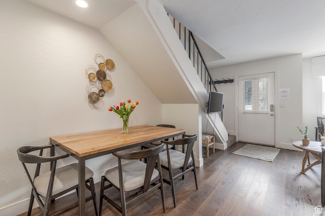 dining room with baseboards, wood finished floors, recessed lighting, and stairway