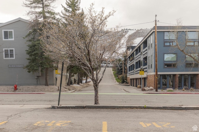 view of road featuring sidewalks and curbs