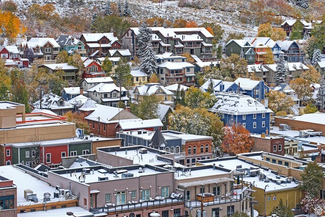 snowy aerial view with a residential view