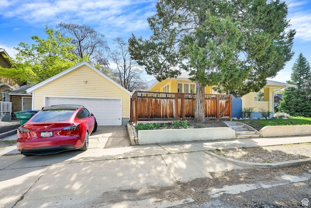 1248 26th St, Ogden, UT 84401 - view of front of home with an outdoor structure, fence, and a garage