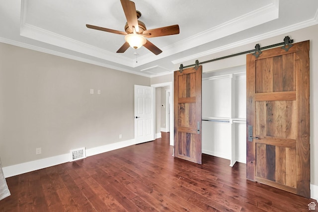 1248 26th St, Ogden, UT 84401 - unfurnished bedroom featuring visible vents, dark wood-style floors, a raised ceiling, and a barn door