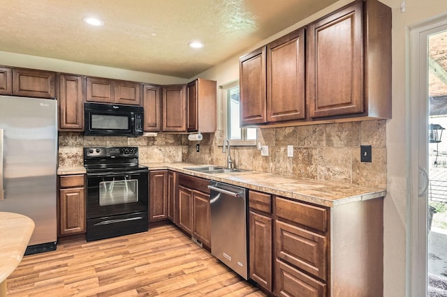 115 S 200 E, Cedar Fort, UT 84013 - kitchen featuring light countertops, light wood-style floors, a sink, and black appliances