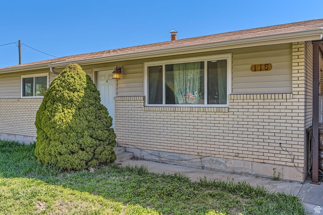 exterior space featuring brick siding