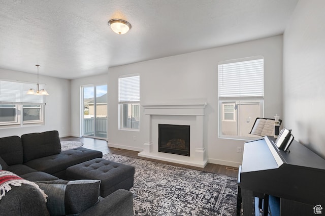 2414 N 4060 W, Lehi, UT 84043 - living area with baseboards, wood finished floors, a fireplace with raised hearth, and a textured ceiling