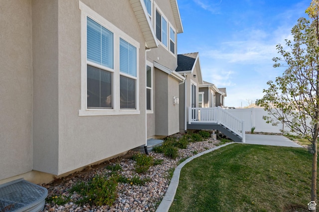 2414 N 4060 W, Lehi, UT 84043 - view of side of property with fence, a yard, and stucco siding