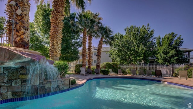 community pool featuring a patio area and fence
