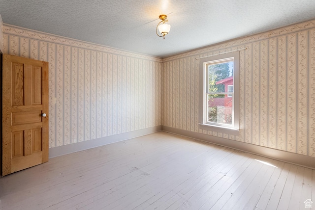 382 N 400 E, Logan, UT 84321 - unfurnished room with baseboards, hardwood / wood-style floors, and wallpapered walls
