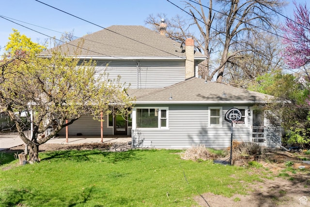 382 N 400 E, Logan, UT 84321 - rear view of house featuring a lawn, a chimney, roof with shingles, and a patio