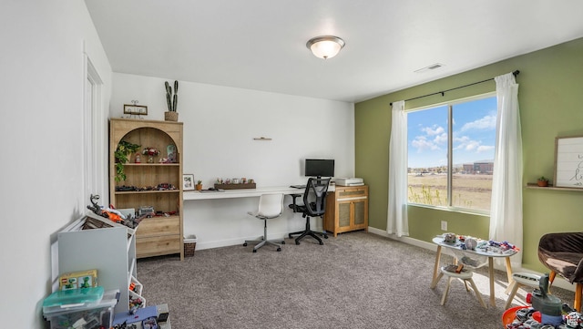 office space featuring carpet floors, visible vents, and baseboards