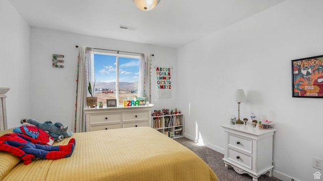 bedroom with dark carpet, baseboards, a mountain view, and visible vents