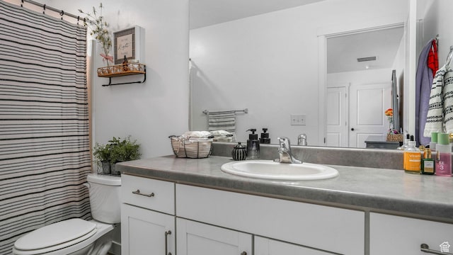 bathroom with toilet, vanity, curtained shower, and visible vents