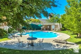 2220 E Murray Holladay Rd S Unit 128, Salt Lake City, UT 84117 - outdoor pool with a patio area and a lawn
