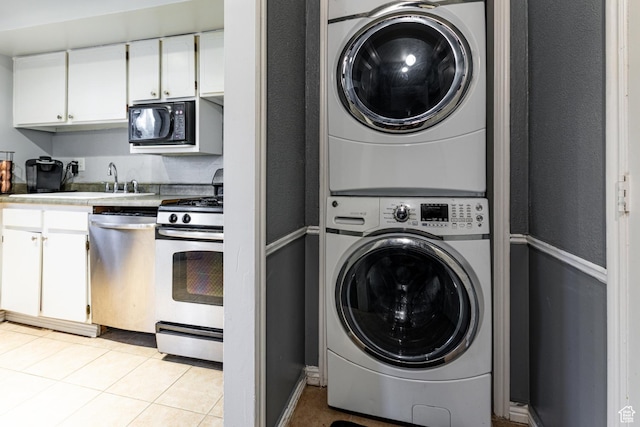 2220 E Murray Holladay Rd S Unit 128, Salt Lake City, UT 84117 - washroom with stacked washer / drying machine, laundry area, and light tile patterned floors