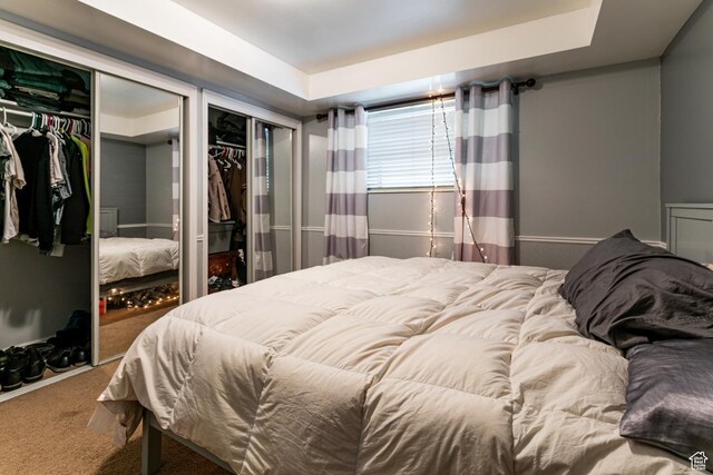2220 E Murray Holladay Rd S Unit 128, Salt Lake City, UT 84117 - carpeted bedroom featuring multiple closets