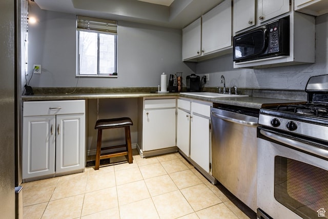 2220 E Murray Holladay Rd S Unit 128, Salt Lake City, UT 84117 - kitchen featuring white cabinets, stainless steel appliances, dark countertops, light tile patterned floors, and a sink