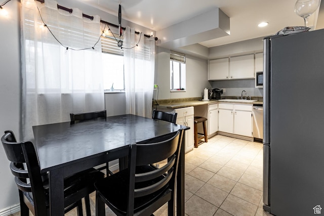 2220 E Murray Holladay Rd S Unit 128, Salt Lake City, UT 84117 - kitchen featuring a sink, freestanding refrigerator, recessed lighting, white cabinetry, and light tile patterned floors