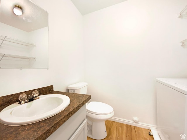 654 W 100 N, Spanish Fork, UT 84660 - bathroom with wood finished floors, vanity, baseboards, toilet, and washer / clothes dryer