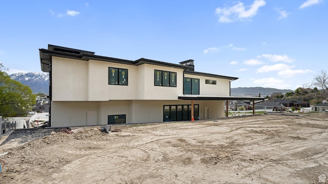 11606 S Halcom Dr, South Jordan, UT 84095 - rear view of house with a mountain view, stucco siding, and fence