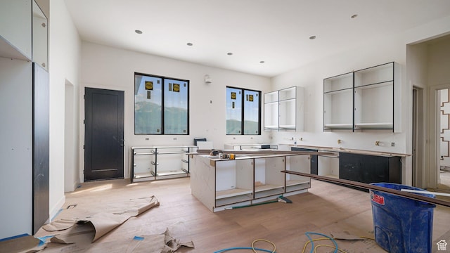 11606 S Halcom Dr, South Jordan, UT 84095 - kitchen featuring a kitchen island and light wood-type flooring