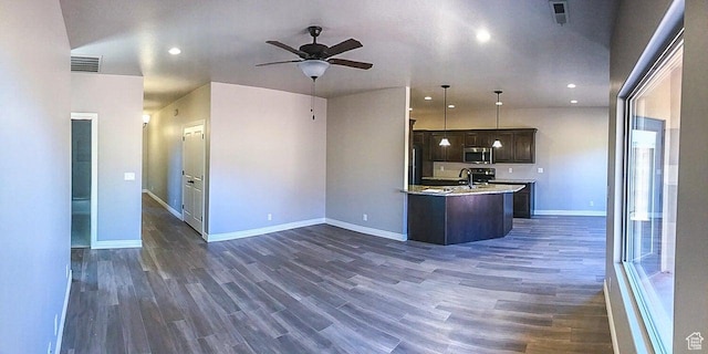 232 W 200 S, Ivins, UT 84738 - kitchen with stainless steel microwave, light countertops, visible vents, and open floor plan