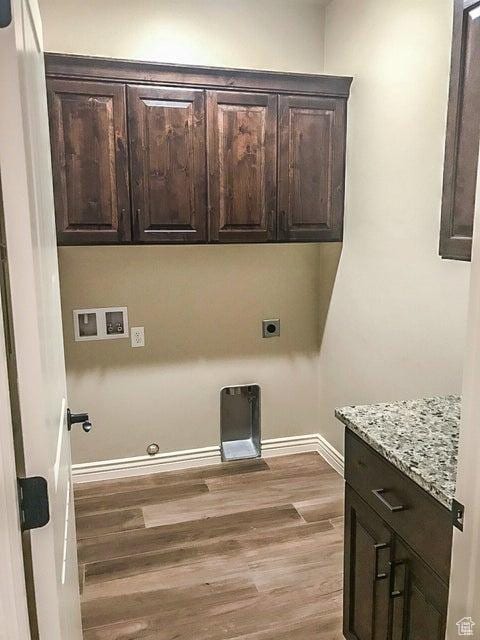 232 W 200 S, Ivins, UT 84738 - washroom featuring wood finished floors, hookup for a gas dryer, hookup for a washing machine, baseboards, and cabinet space