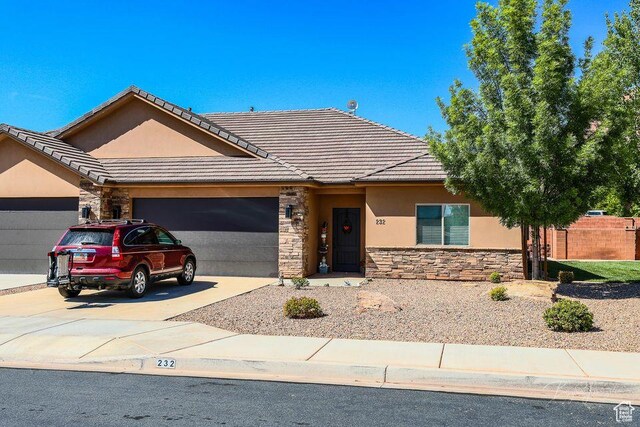 232 W 200 S, Ivins, UT 84738 - ranch-style home with a garage, a tile roof, stone siding, and stucco siding
