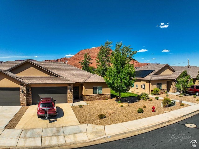 232 W 200 S, Ivins, UT 84738 - single story home with a tiled roof, stucco siding, driveway, stone siding, and a garage